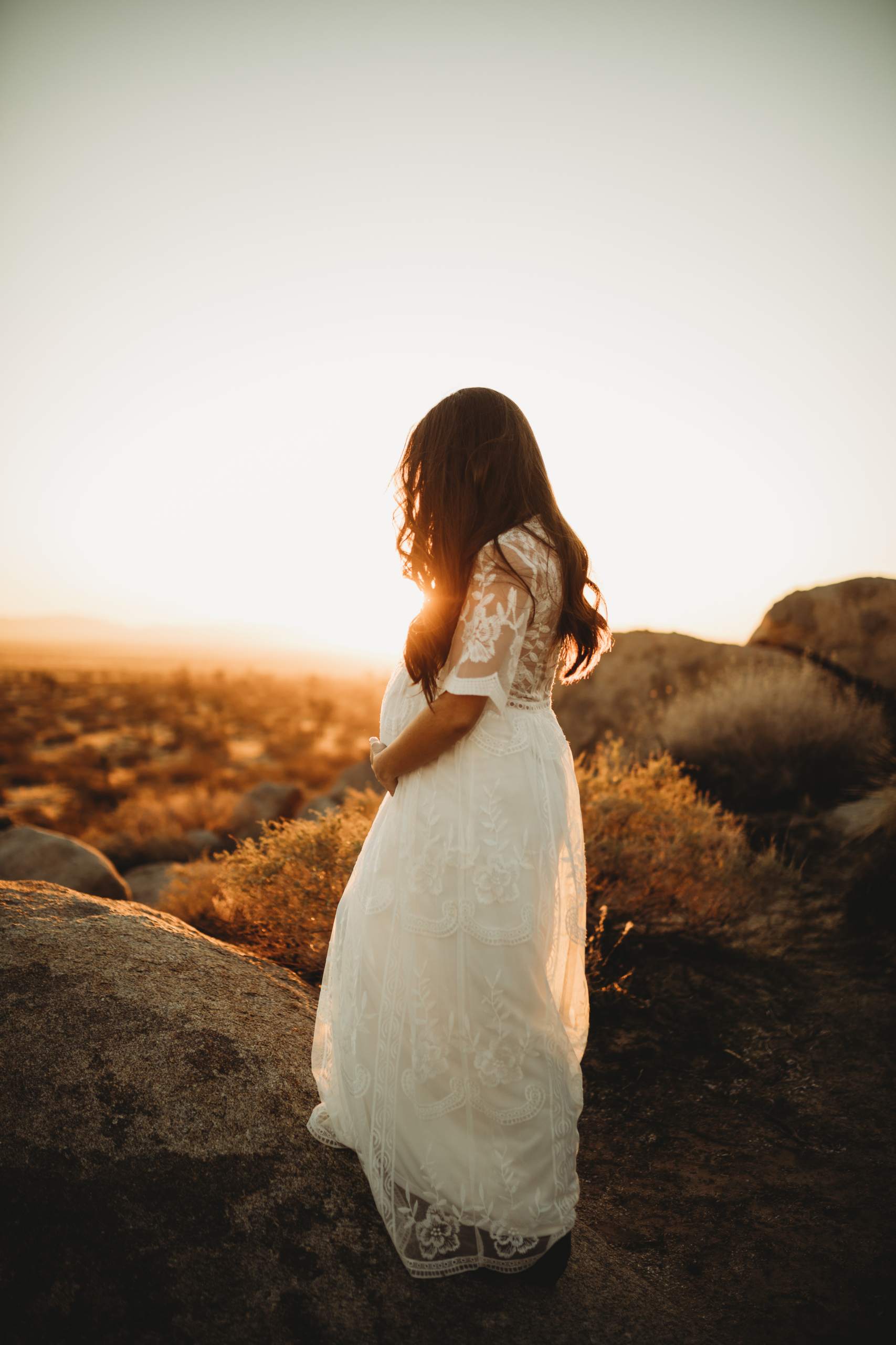 33 weeks pregnant, Nancy over looks the Antelope Valley Desert at sunset. 